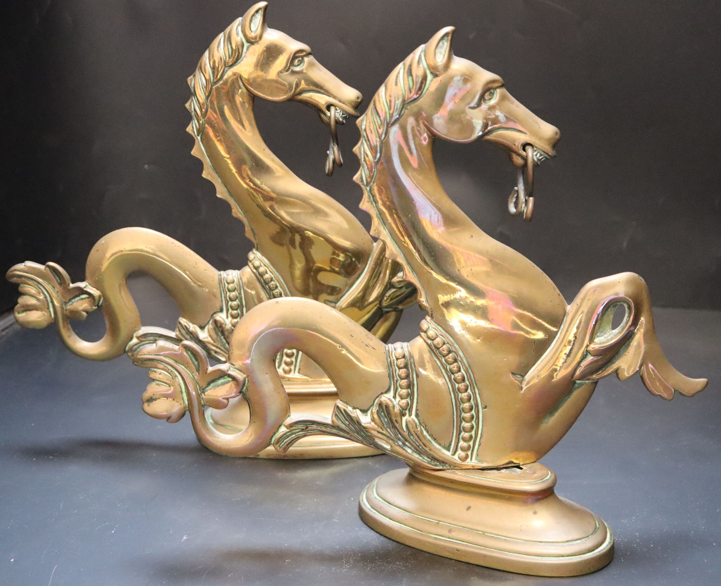 A pair of Venetian brass seahorse gondola finials, height 31cm